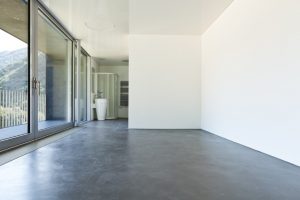 Image depicts a modern hotel room with recently polished concrete floors.