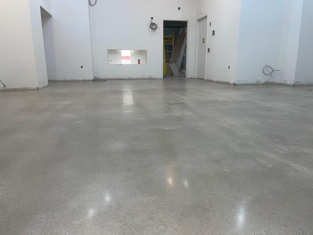 Image depicts a concrete floor in a Wasaga Beach Vape Shop that has been polished by Polished Floors.