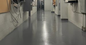 Image depicts a grey epoxy floor with anti-slip in a factory in Toronto.