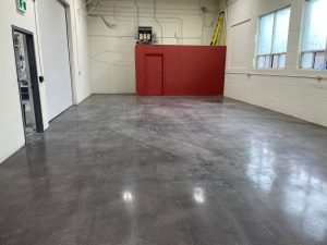 Image depicts a showroom in Mississauga with polished floors and black stain.