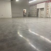 Image depicts a warehouse floor in Milton with concrete floors that have been polished.