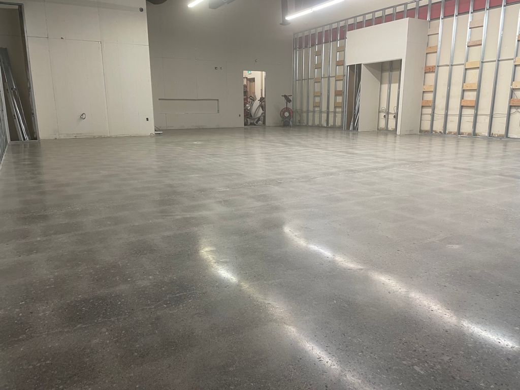 Image depicts a warehouse floor in Milton with concrete floors that have been polished.