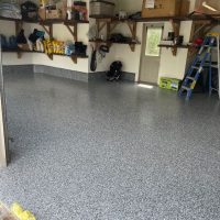 Image depicts a garage from our epoxy 2-car garage Woodbridge project, showing a garage with new epoxy flooring.