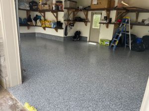 Image depicts a garage from our epoxy 2-car garage Woodbridge project, showing a garage with new epoxy flooring.