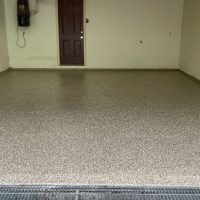 Image depicts a 1-car garage in Toronto with new epoxy floors.