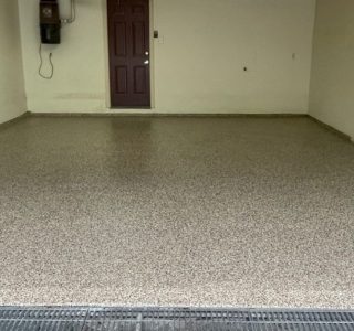 Image depicts a 1-car garage in Toronto with new epoxy floors.