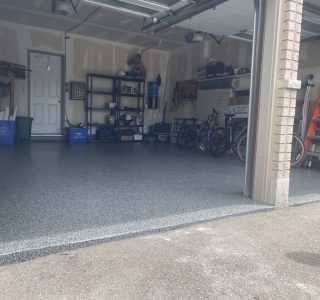 Image depicts a garage from our epoxy 2-car garage Maple project, showing a garage with new epoxy flooring.