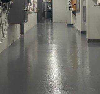 Image depicts a grey epoxy floor with anti-slip in a factory in Toronto.