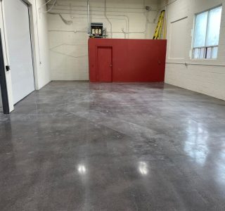 Image depicts a showroom in Mississauga with polished floors and black stain.